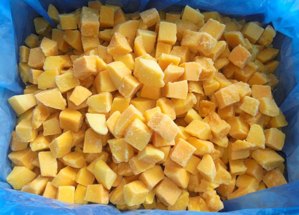 Golden yellow IQF frozen mango chunks.